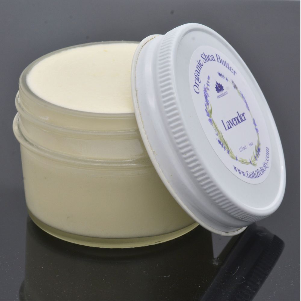 Open jar of organic shea butter with a white lid on a dark background